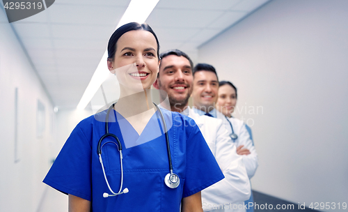 Image of group of happy medics or doctors at hospital