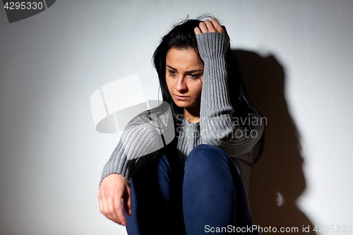 Image of unhappy woman crying on floor