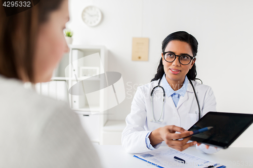 Image of doctor with tablet pc and woman patient at clinic