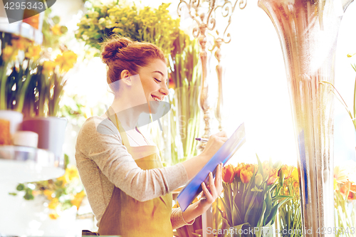 Image of florist woman with clipboard at flower shop