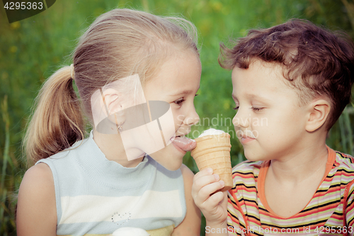 Image of Two happy children  playing in the park at the day time.