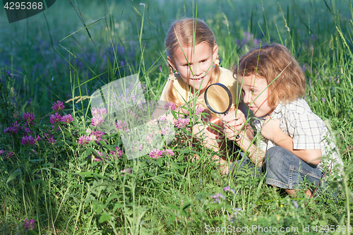 Image of Two happy children  playing in the park at the day time.