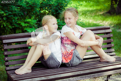 Image of Two happy children  playing in the park at the day time.