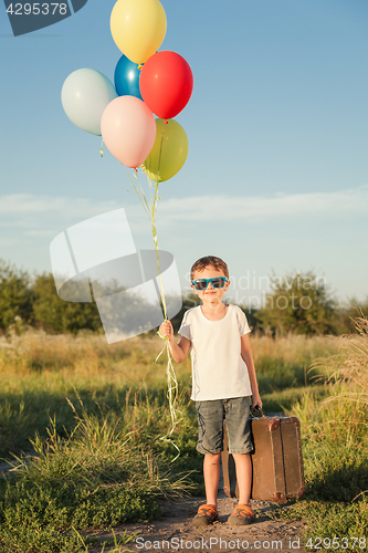 Image of Happy little boy playing on road at the day time.