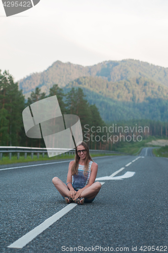 Image of Woman sitting on the road