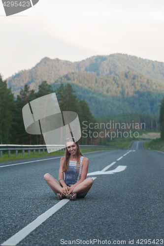 Image of Woman sitting on the road