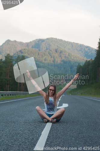 Image of Woman sitting on the road