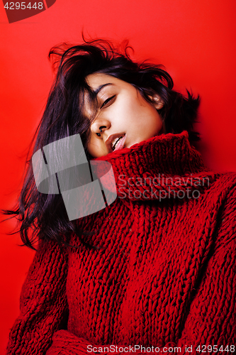 Image of young pretty indian mulatto girl in red sweater posing emotional, fashion hipster teenage, lifestyle people concept 