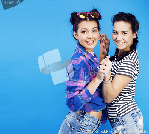 Image of best friends teenage school girls together having fun, posing emotional on blue background, besties happy smiling, lifestyle people concept 