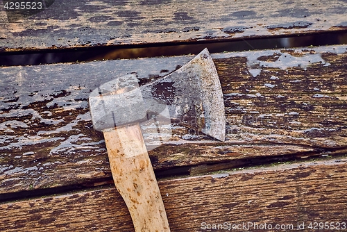 Image of Axe on wet planks