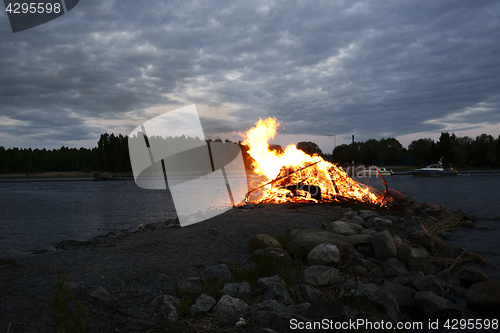 Image of traditional bonfire on the summer solstice on the shore of the l