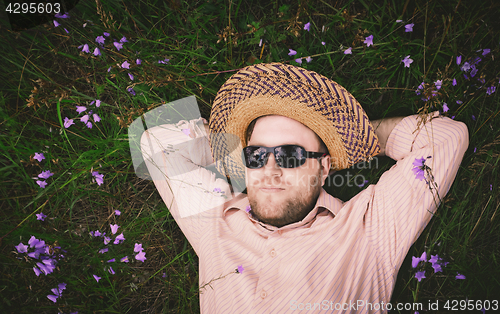 Image of Man Rest On The Grass And Bellflowers