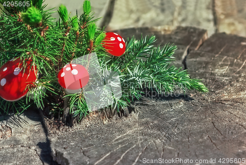 Image of Juniper Branch And Red Mushrooms On The Old Wooden Background