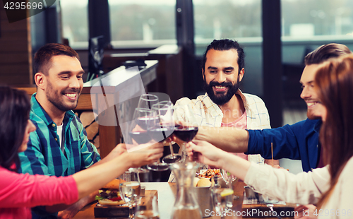 Image of friends dining and drinking wine at restaurant
