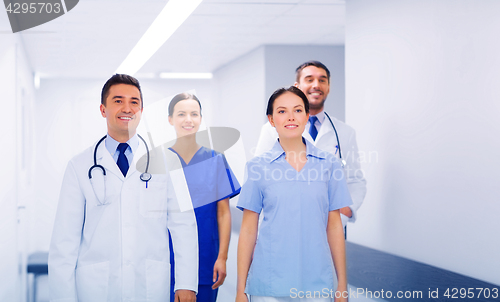 Image of happy group of medics or doctors at hospital