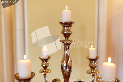 Image of candles burning in church or palace