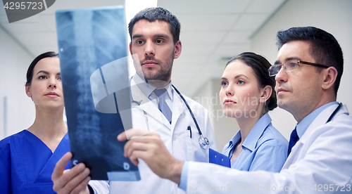 Image of group of doctors looking at x-ray scan image