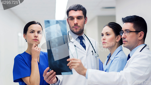 Image of group of medics with spine x-ray scan at hospital