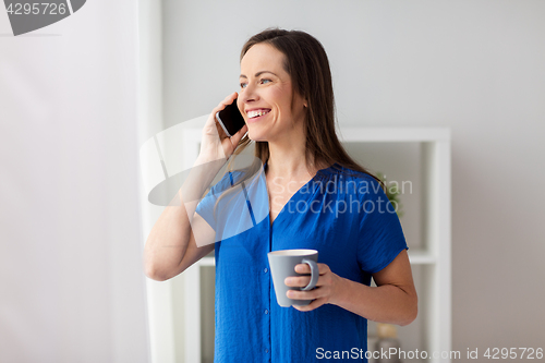 Image of woman calling on smartphone at office or home