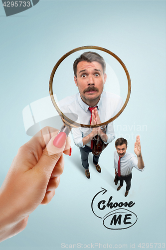 Image of Closeup portrait of smiling, happy, surprised, young business man, on blue background.