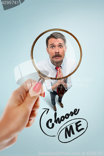 Image of Closeup portrait of smiling, happy, surprised, young business man, on blue background.