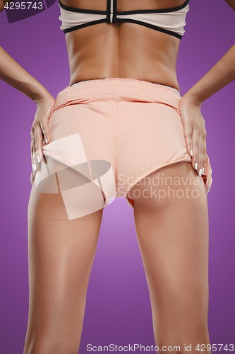 Image of Muscular young woman athlete posing at studio