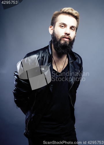 Image of portrait of young bearded hipster guy on gray dark background close up, brutal modern man, lifestyle people concept 