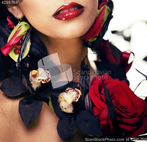 Image of pretty brunette woman with rose jewelry, black and red, bright m