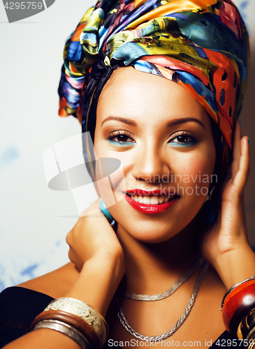 Image of beauty bright african woman with creative make up, shawl on head