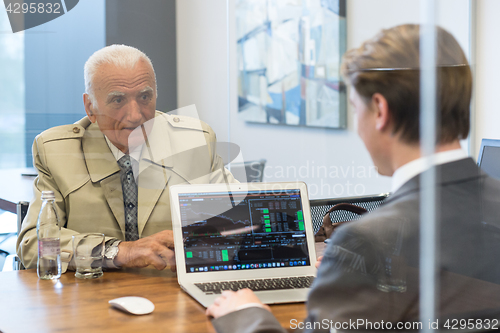 Image of Financial advisor consulting senior client with his investment strategy.