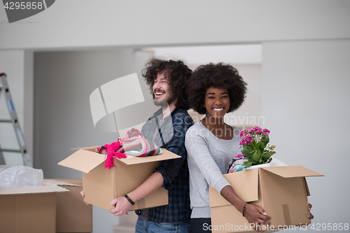 Image of multiethnic couple moving into a new home