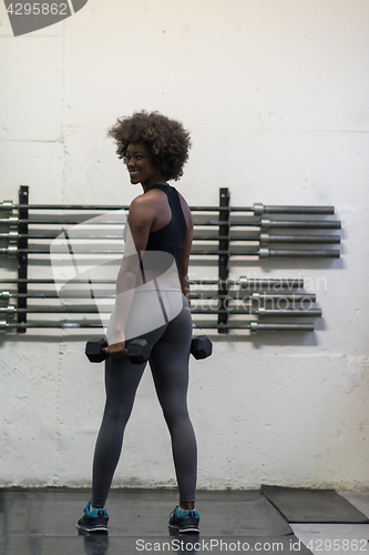 Image of black woman doing bicep curls