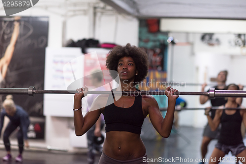 Image of black woman lifting empty bar