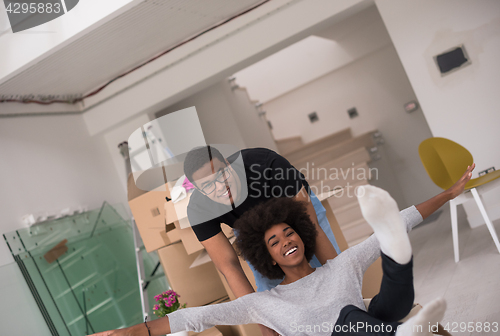 Image of African American couple  playing with packing material