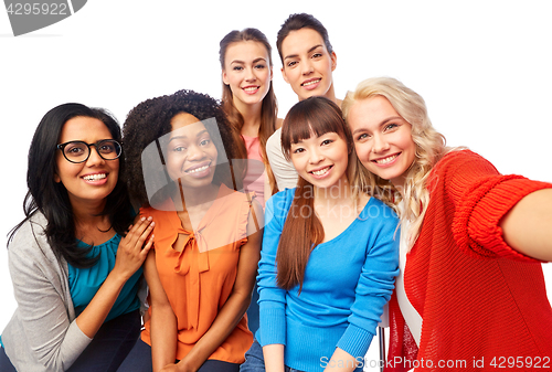 Image of international group of happy women taking selfie