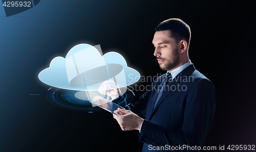 Image of businessman with tablet pc and cloud projection