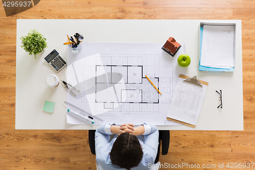 Image of architect with house blueprint at office