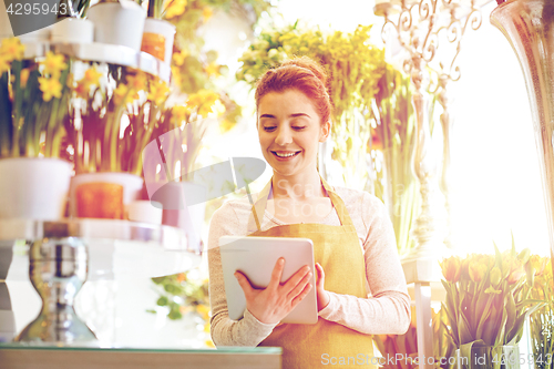 Image of woman with tablet pc computer at flower shop