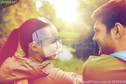 Image of smiling couple with backpacks in nature