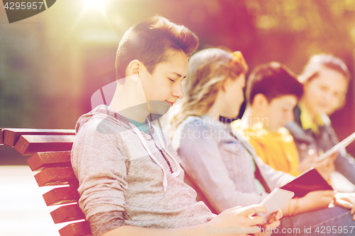 Image of happy teenage boy with tablet pc computer outdoors