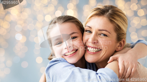 Image of happy family of girl and mother hugging