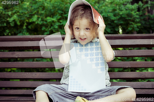 Image of happy little boy sitting on bench