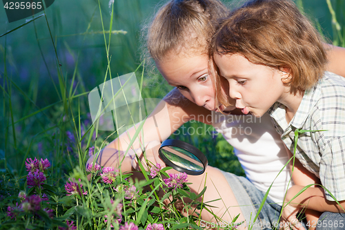 Image of Two happy children  playing in the park at the day time.