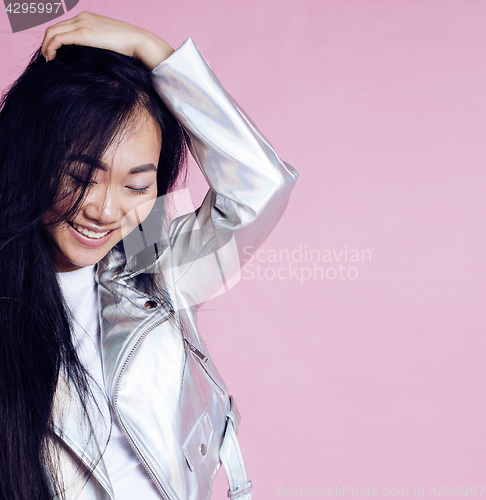 Image of young pretty smiling asian korean girl wearing modern fashion clothers on pink background, lifestyle people concept 