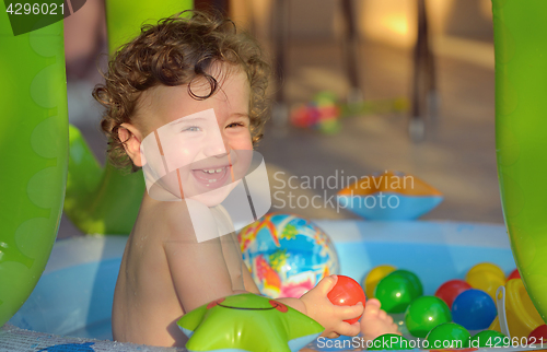 Image of Laughing little girl swimming in the pool 