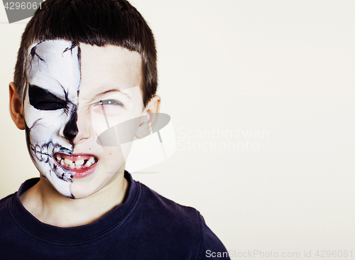 Image of little cute boy with facepaint like skeleton to celebrate hallow