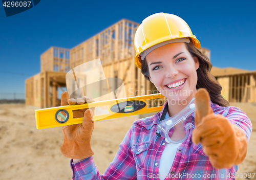 Image of Female Construction Worker with Thumbs Up Holding Level Wearing 