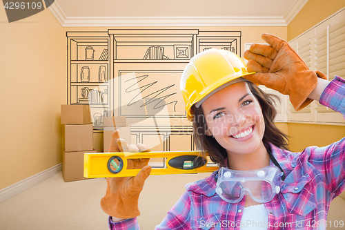 Image of Female Construction Worker Holding Level In Front of Custom Buil