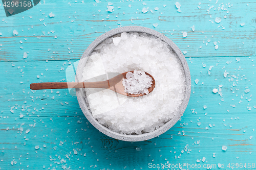 Image of sea salt on wooden background