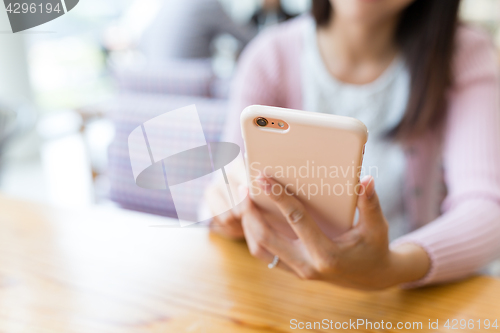 Image of Woman sending sms on cellphone